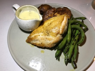 chicken with charred green beans, smashed red skin potatoes, and tarragon beurre blanc